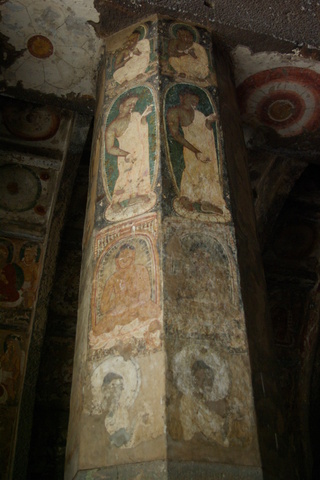 painted column depicting the Buddha