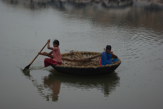 Image of two girls paddling a Coracle