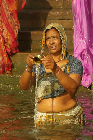 image of woman performing ritual in the Ganges